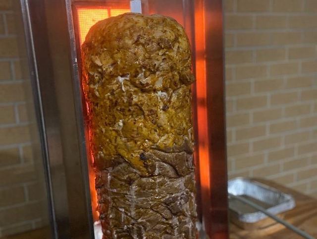 A doner slowly roasting beside the heater