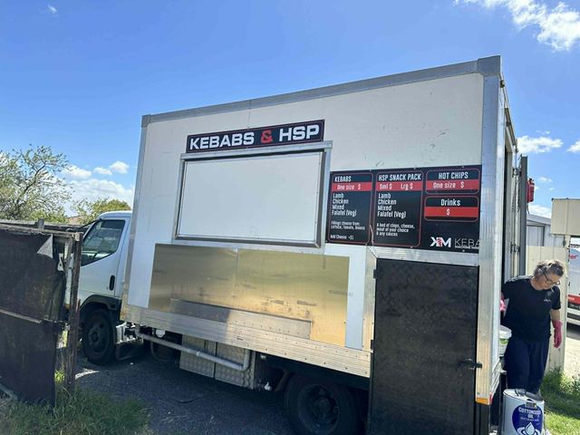 The Kebabs and HSP service window on the side of the truck