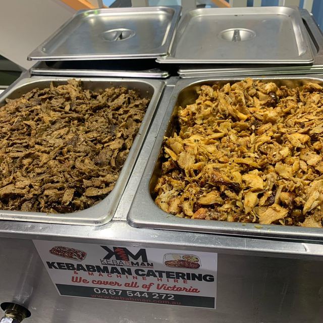 Trays of shaved chicken and lamb in the bain marie with the Kebabman sign